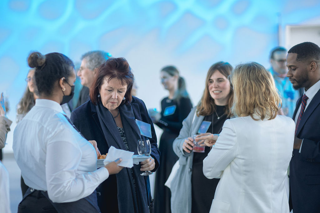 Photo of people speaking with one another during a reception