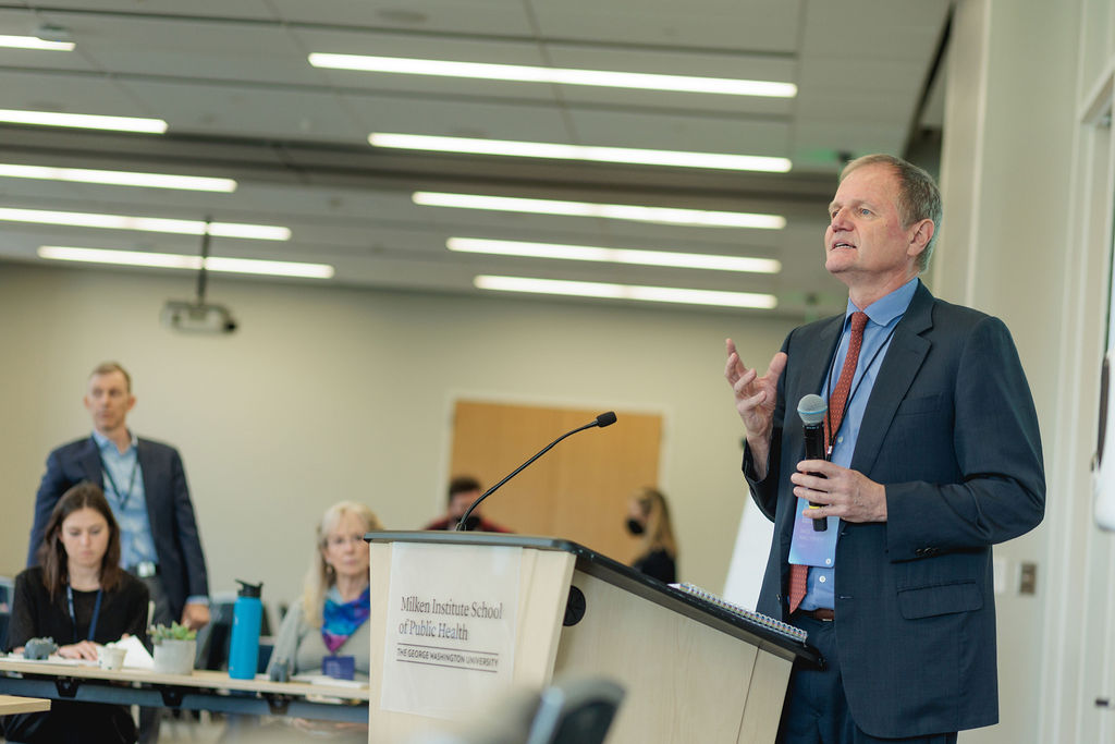 a man speaking behind a podium