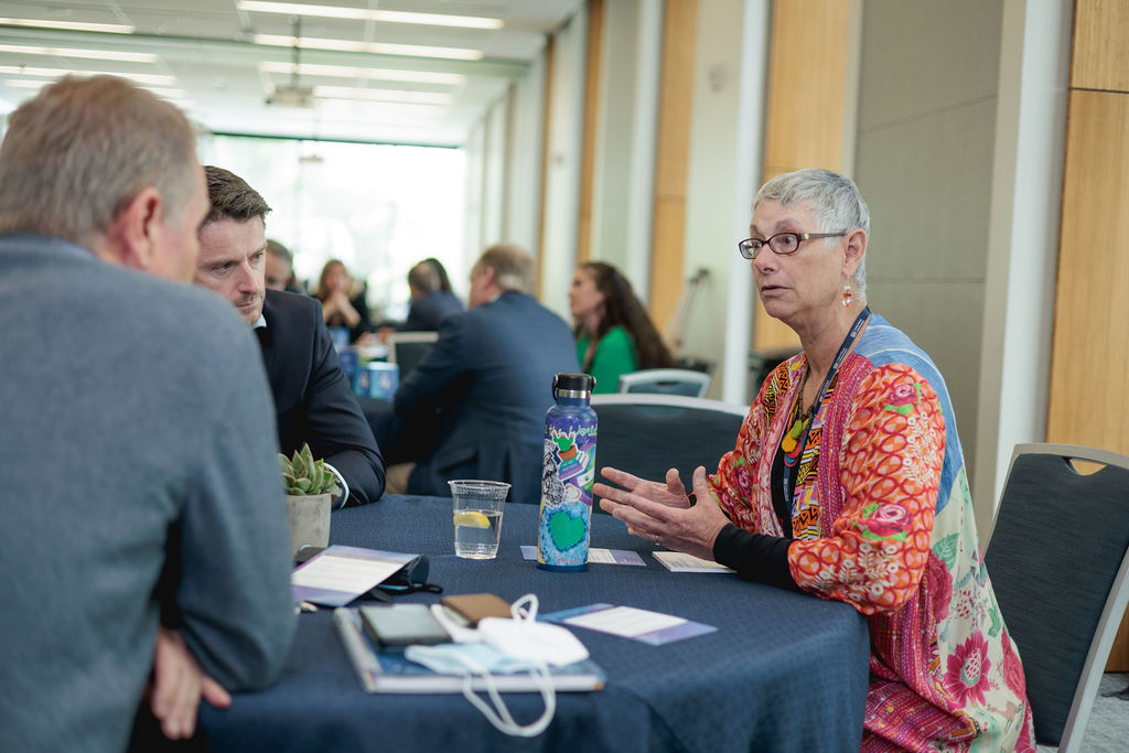 people speaking at a table