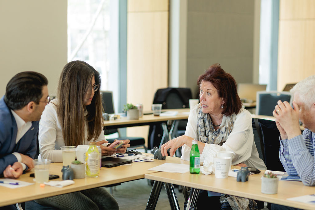 people working together at two tables