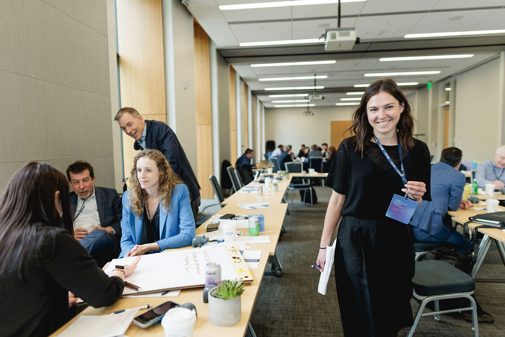 a woman walks past a group discussion