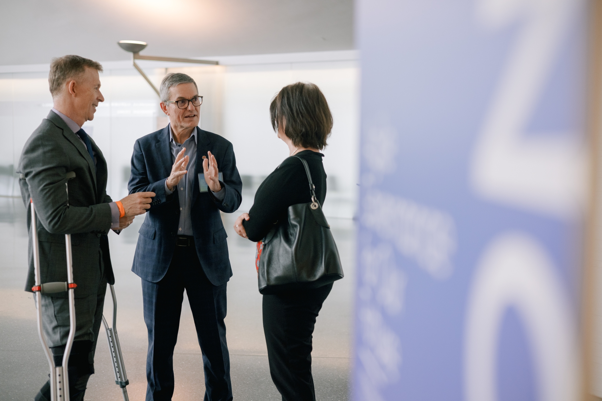 Photo of three people talking