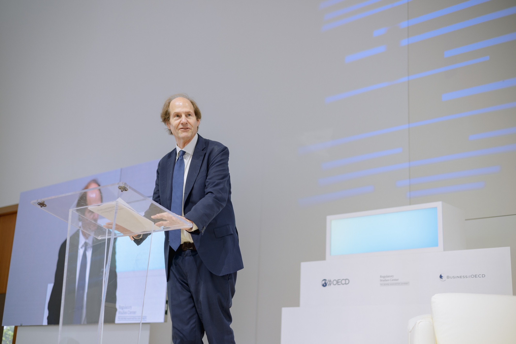 Cass Sunstein speaking at a podium