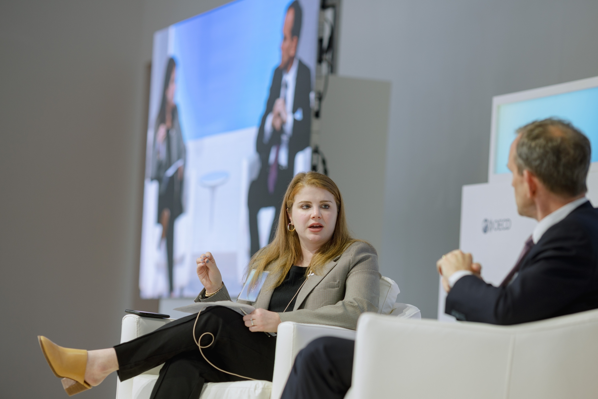 Kent Walker and Ashley Gold seated on stage