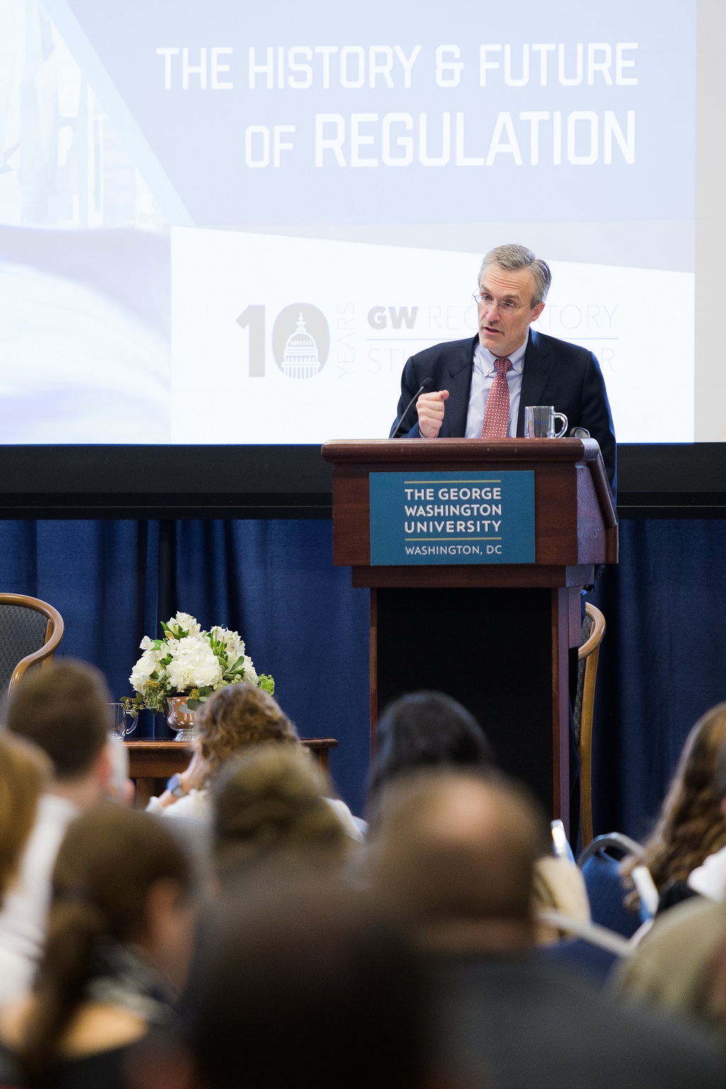 Cary Coglianese standing at a podium