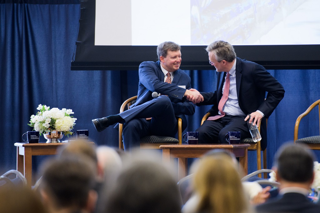 Christopher Carrigan and Cary Coglianese sitting down and shaking hands