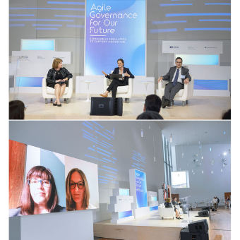 Photo of panelists seated on stage and on screen
