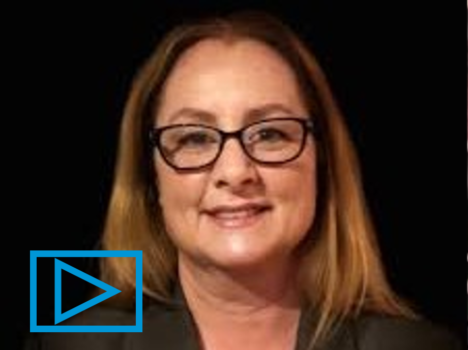 Photo of Cheryl Bolen in front of a black background.