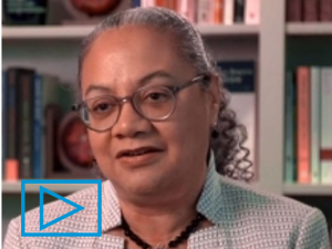 Photo of Shawne McGibbon seated in front of a bookcase.