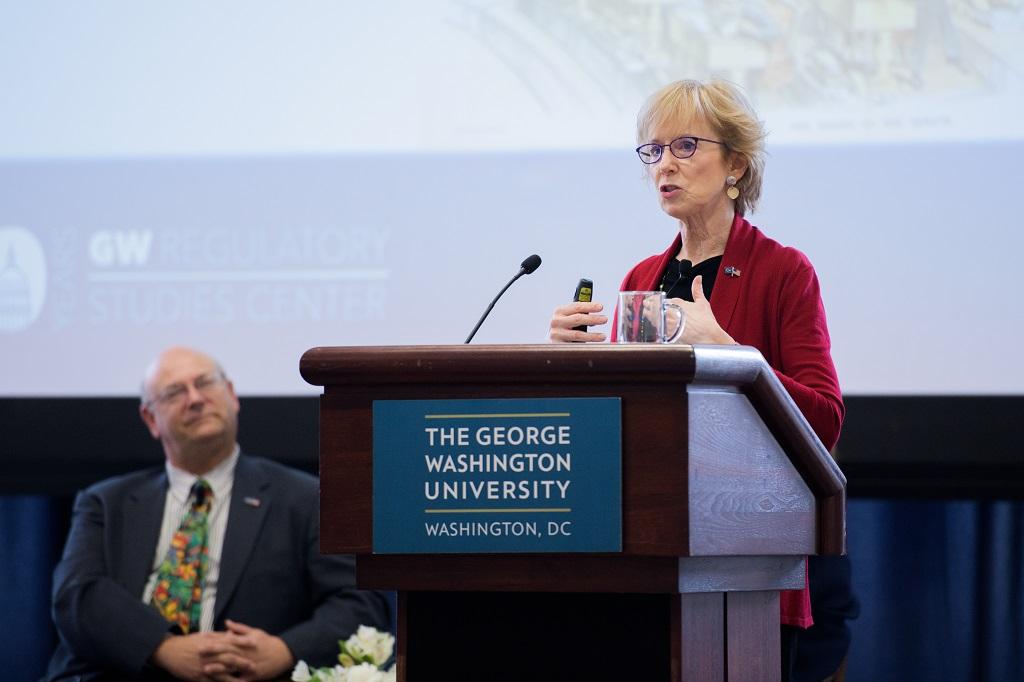 Susan Dudley standing at a podium
